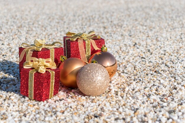 Christmas decorations and balls on the sand of a beach