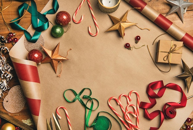 Christmas decorations balls over wrapping paper top view