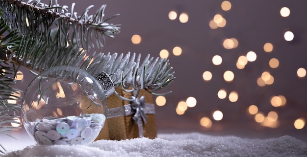 Christmas decorations banner. Snowy Fir-tree branch with Christmas lights bokeh. Panoramic background. Xmas composition. New Year 2020 holidays