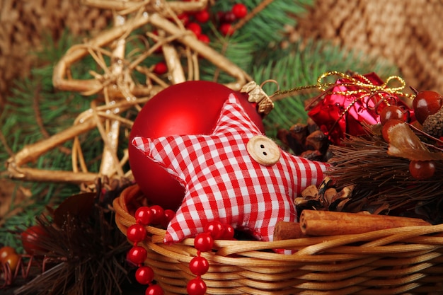 Christmas decorations in basket and spruce branches close up