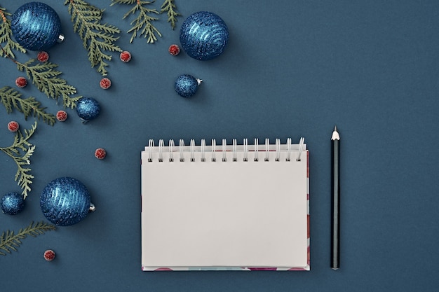 The Christmas decorations on blue background with various objects for writing