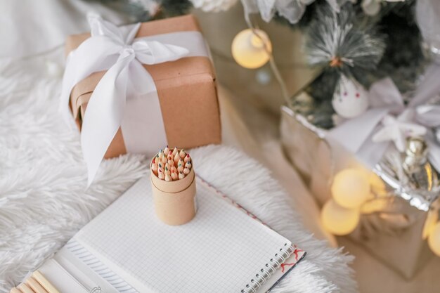 Christmas decorations boxes wrapped in wood colored paper and pencils made of wood