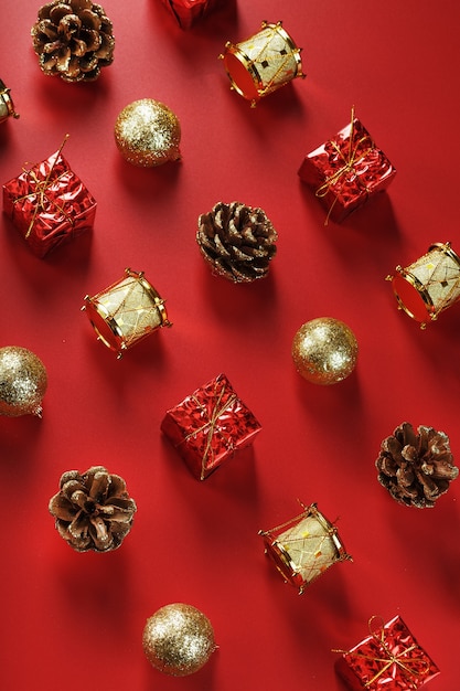 Christmas decorations on the Christmas tree pattern on a red wall. Top view, as a wall. New Year holiday