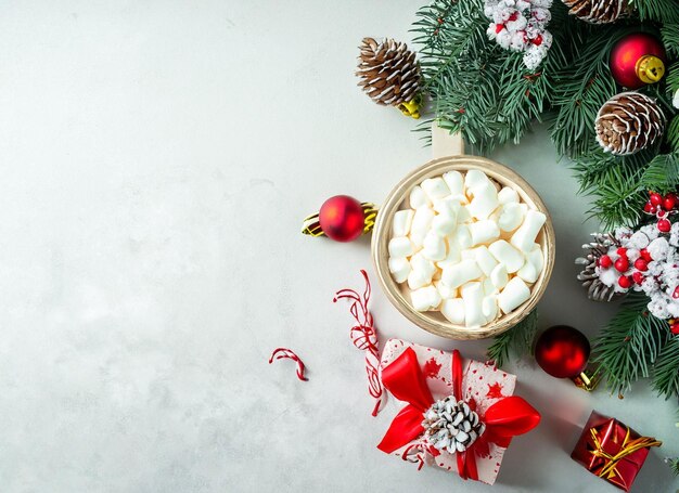 Christmas decorations concept Top view photo of gold and green baubles balls star ornaments confetti and pine branches on isolated white background with empty space