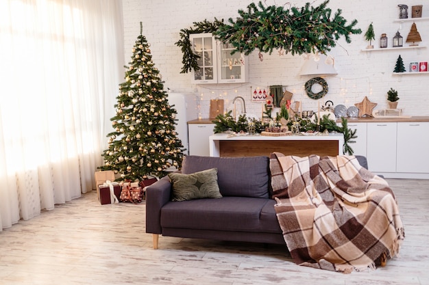 Christmas decorations in a cozy home with a white kitchen on New Year's Eve. Christmas atmosphere