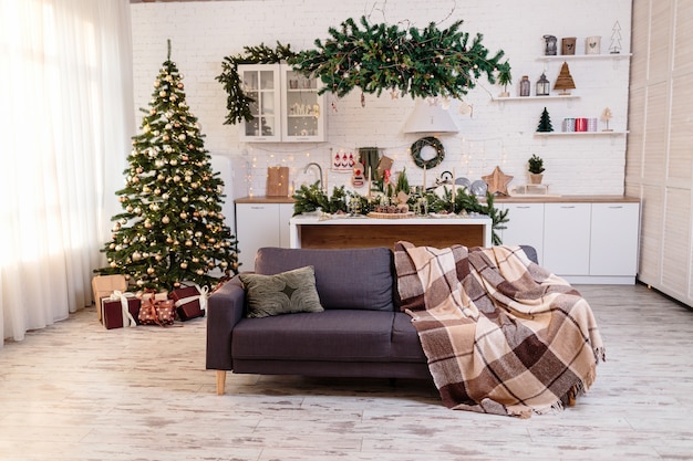 Christmas decorations in a cozy home with a white kitchen on New Year's Eve. Christmas atmosphere