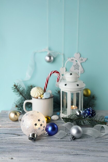 Christmas decorations a cup of coffee with meringues and marshmallows a lantern