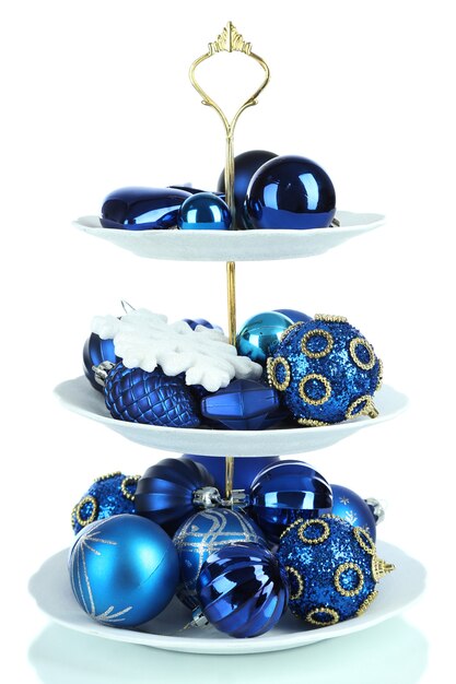 Christmas decorations on dessert stand, isolated on white