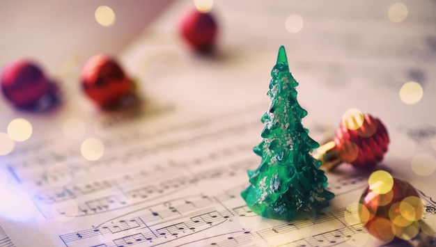 Christmas decorations and fir branch lying on notes sheet