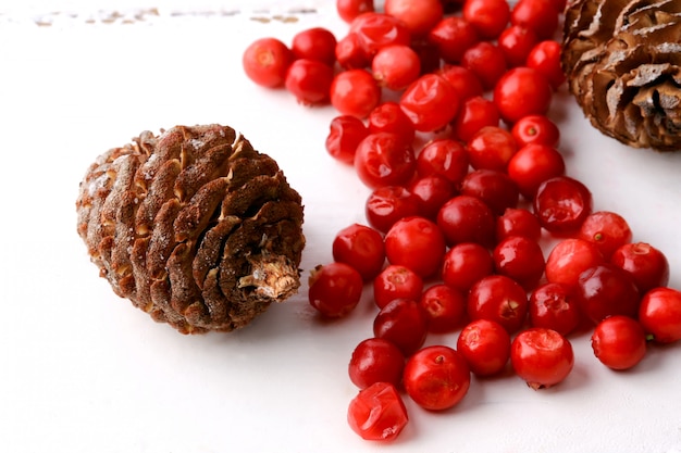 Christmas decorations  fir cones cranberries rustic winter white wooden