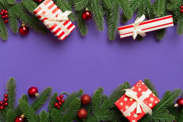 Christmas decorations and fir tree branch and gift boxon dark table. Top view frame with copy space