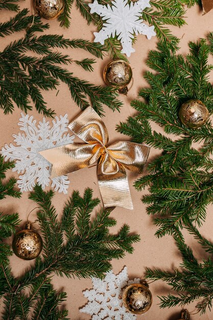 Christmas decorations flat layout with many fir branches on the cardboard background