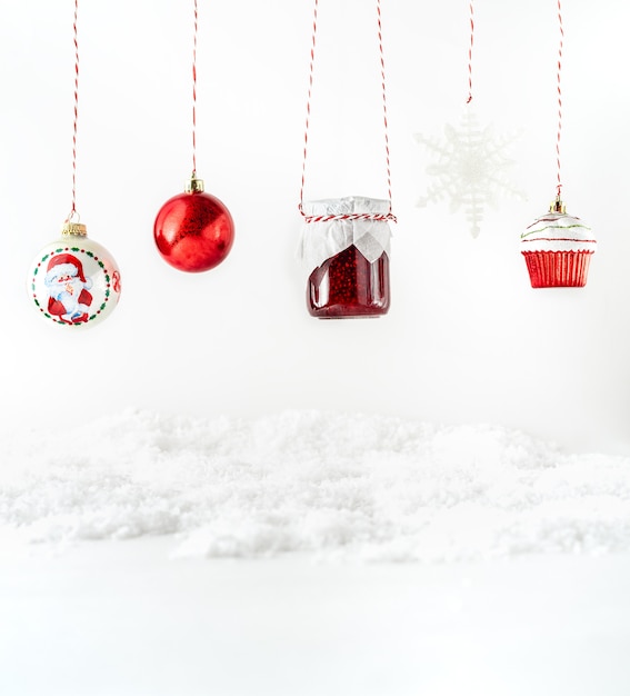 Christmas decorations, fruit jam in a glass jar hanging on ropes