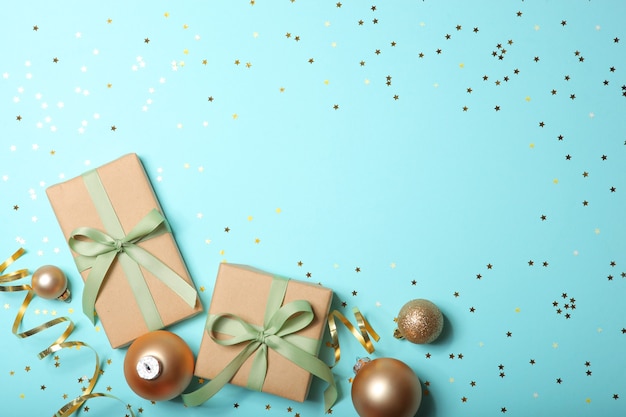 Christmas decorations and gifts on a colored background top view