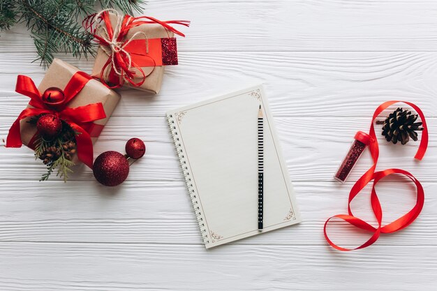 Christmas decorations, gifts and food on a white wooden background. 