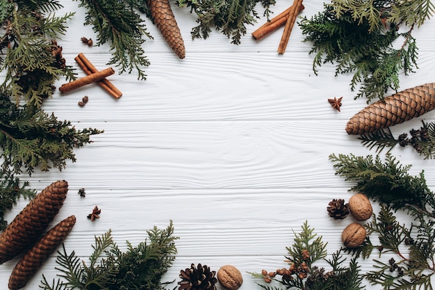 Christmas decorations, gifts and food on a white wooden background.