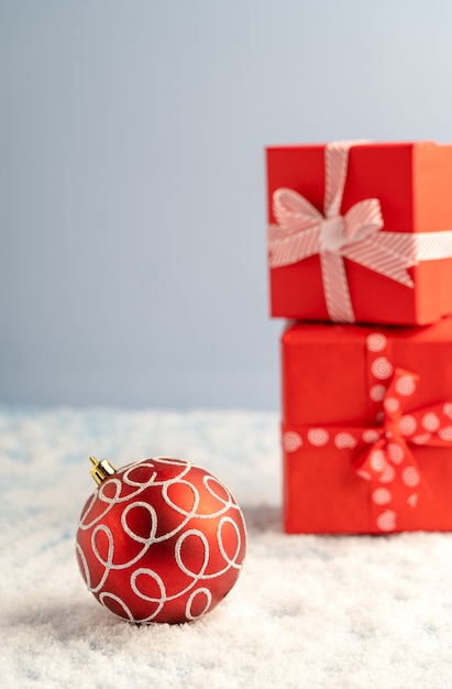 Christmas decorations and gifts in red boxes on the table side view. Background for Happy New Year and Christmas greetings