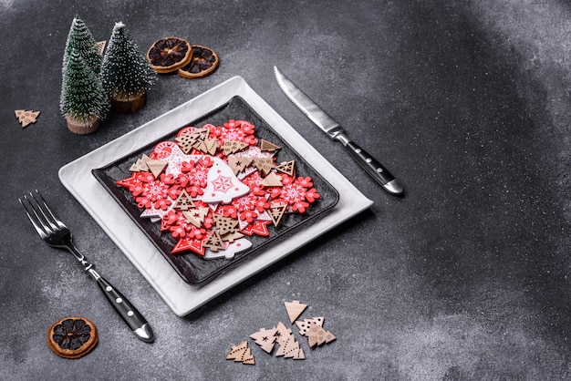 Christmas decorations and gingerbreads on a dark concrete table Getting ready to celebration