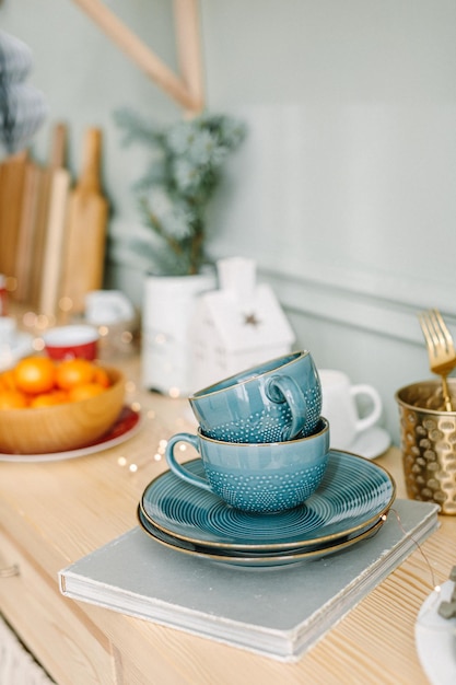 Christmas decorations on kitchen. Christmas tableware. Christmas cups and balls