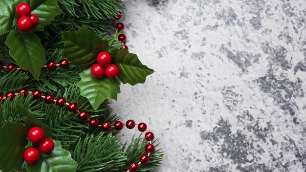 Christmas decorations pine tree leaves balls berries on grunge background
