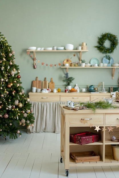 Christmas decorations Scandinavian kitchen. Christmas tree with golden balls. Kitchen wooden island