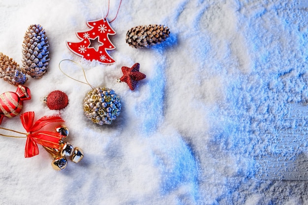 Christmas decorations in snow with blue backlight.