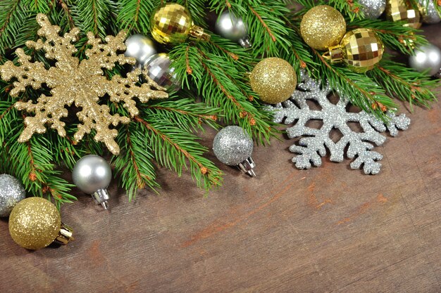 Christmas decorations and spruce branch on a wooden background