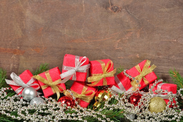 Christmas decorations and spruce branch on a wooden background