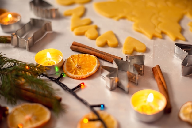 Christmas decorations on the table near flat cut dough ready for baking