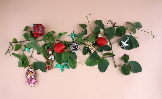 Christmas decorations and vines with light yellow background.