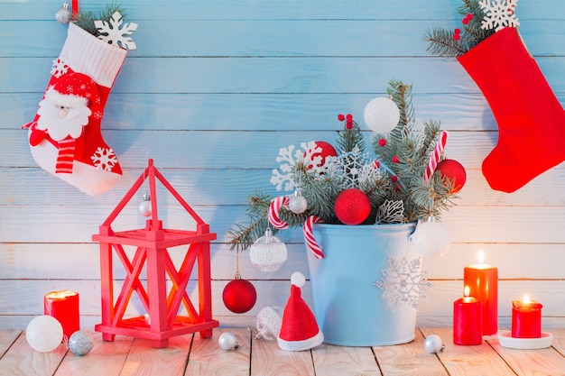 Christmas decorations with burning candles on blue wooden backgr