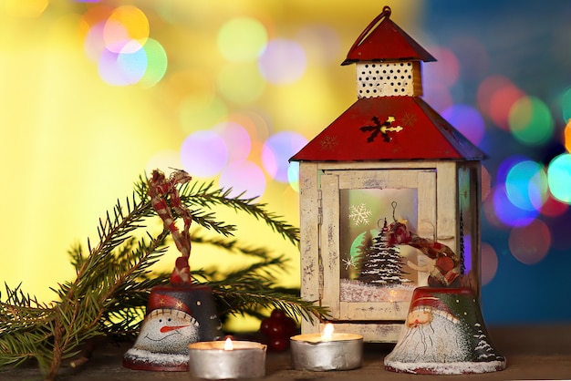 Christmas decorations with candles under; colored blurred background.