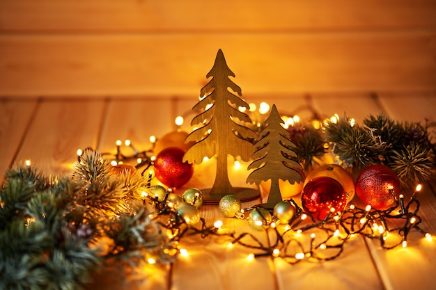 Christmas decorations with lights on a wooden surface