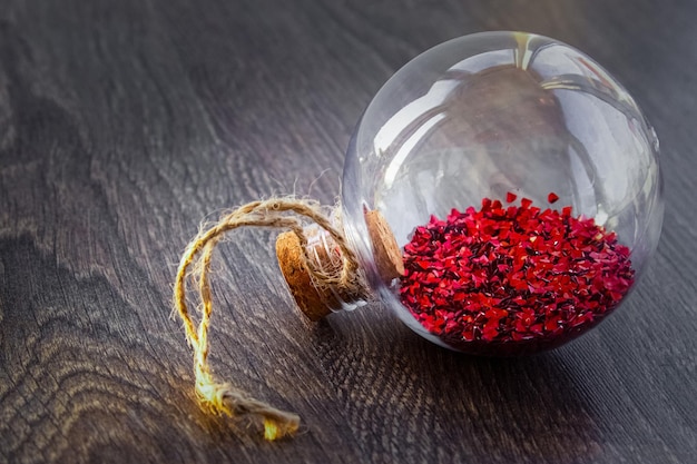 Christmas decorations with transparent glass ball , spruce branch and cone, red stars scattered