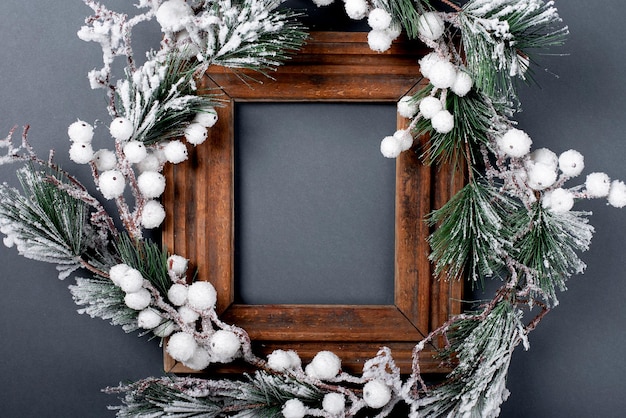 Christmas decorations and wooden frame Fir branch on a gray background copy space