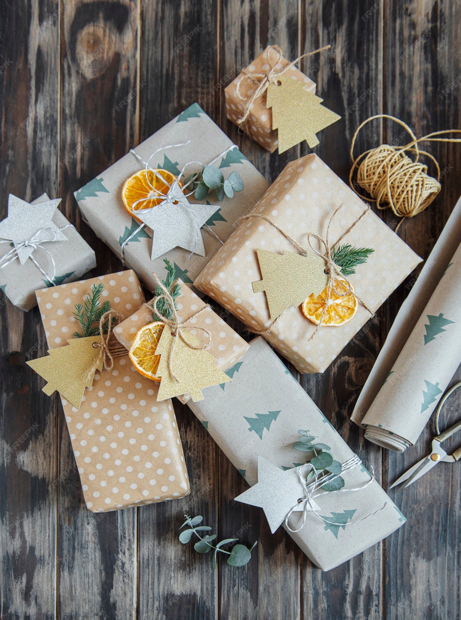 Premium Photo  Christmas decorative homemade gift boxes wrapped in brown  kraft paper on a dark gray wooden background