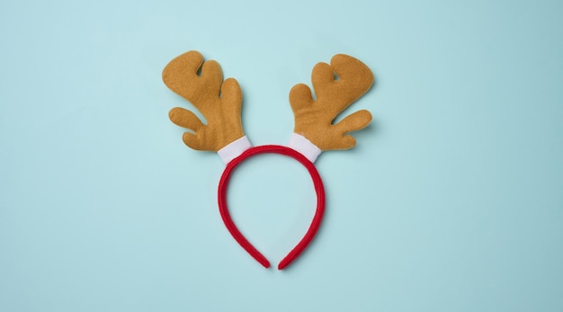 Christmas deer costume with antlers on the head on a blue background