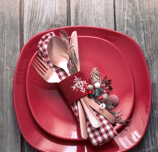 Christmas dinner cutlery with decor on a wooden table