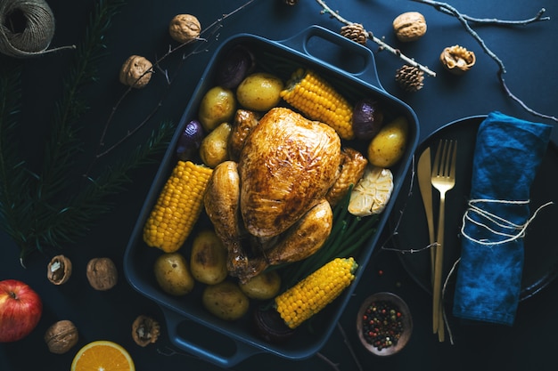 Christmas dinner table with chicken on dark