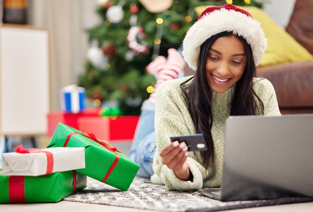 Christmas e commerce and woman with laptop credit card for online payment for gift with internet banking female customer smile for holiday donation or shopping for present fintech and bank app