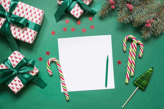 Christmas empty blank letter to Santa or invitation on green. Top view.