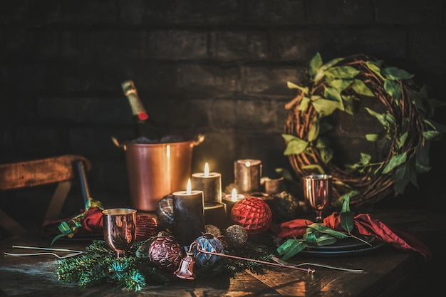 Christmas eve holiday festive table setting with champagne and candles