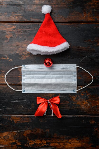 Christmas face from decorations and mask set, on old dark  wooden table background, top view flat lay