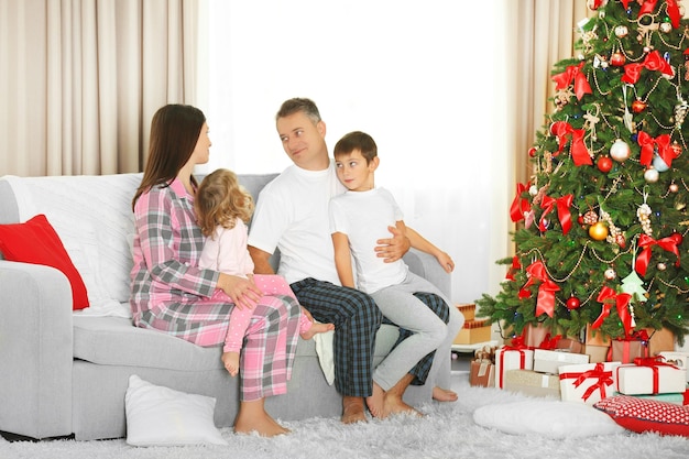 Christmas family portrait in home holiday living room, at christmas morning