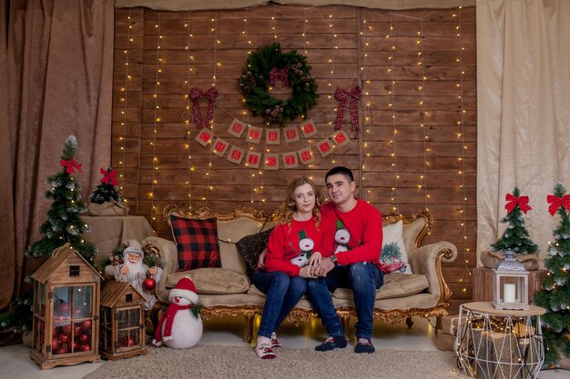 Christmas Family Portrait in Xmas Tree Interior Lights Happy New Year The concept of family winter holiday