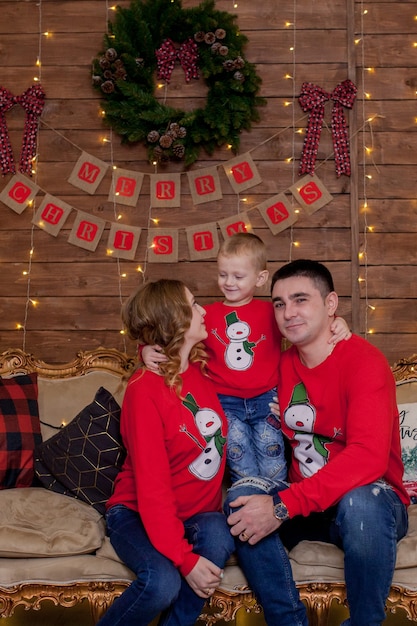 Christmas Family Portrait in Xmas Tree Interior Lights Happy New Year