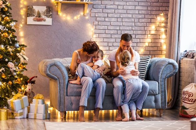 Christmas family with two kids in beautiful living room