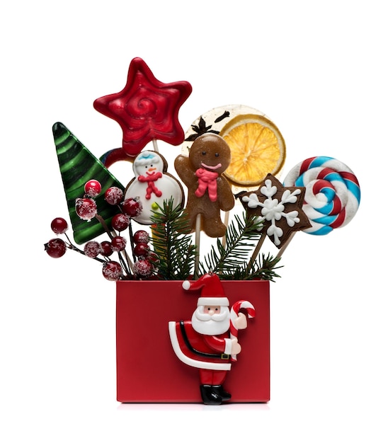 Christmas festive card with Christmas gingerbread and candy on sticks in gift box