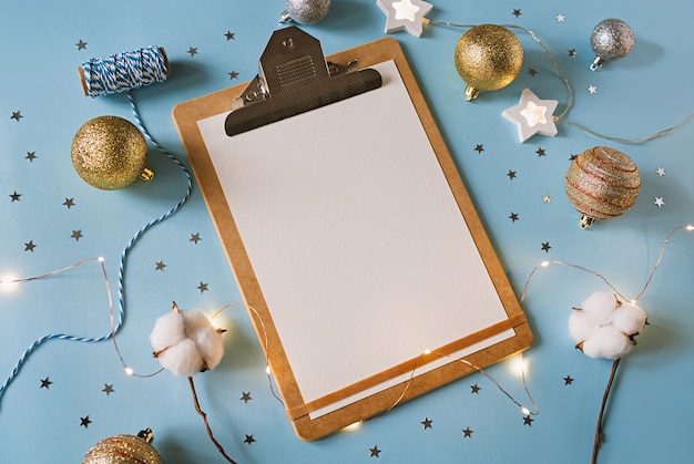 Christmas festive decorations and Paper on clipboard .