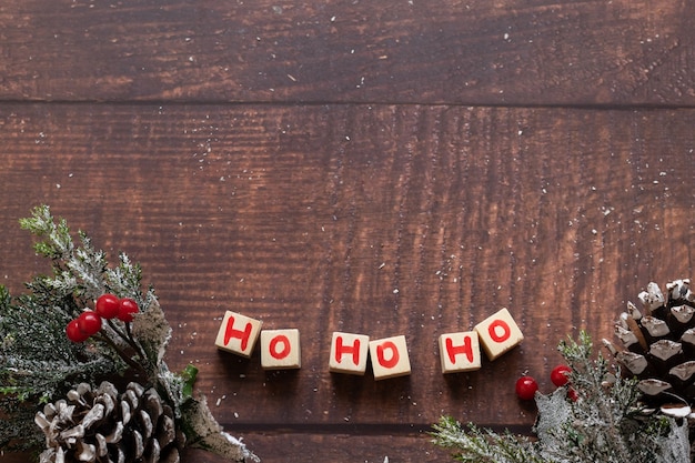 Christmas festive Ho Ho Ho text  and seasons decorations on wooden background, space for text